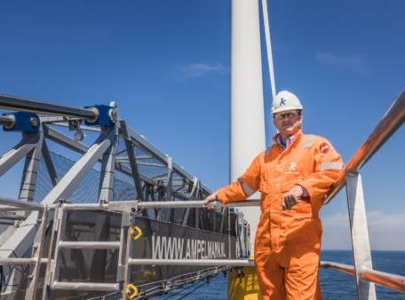 man next to windturbine