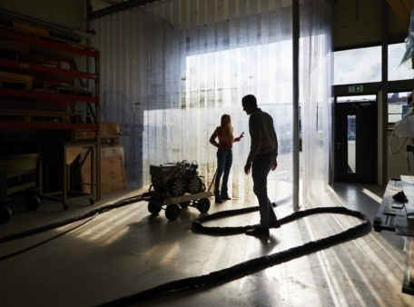 people in warehouse backlighting